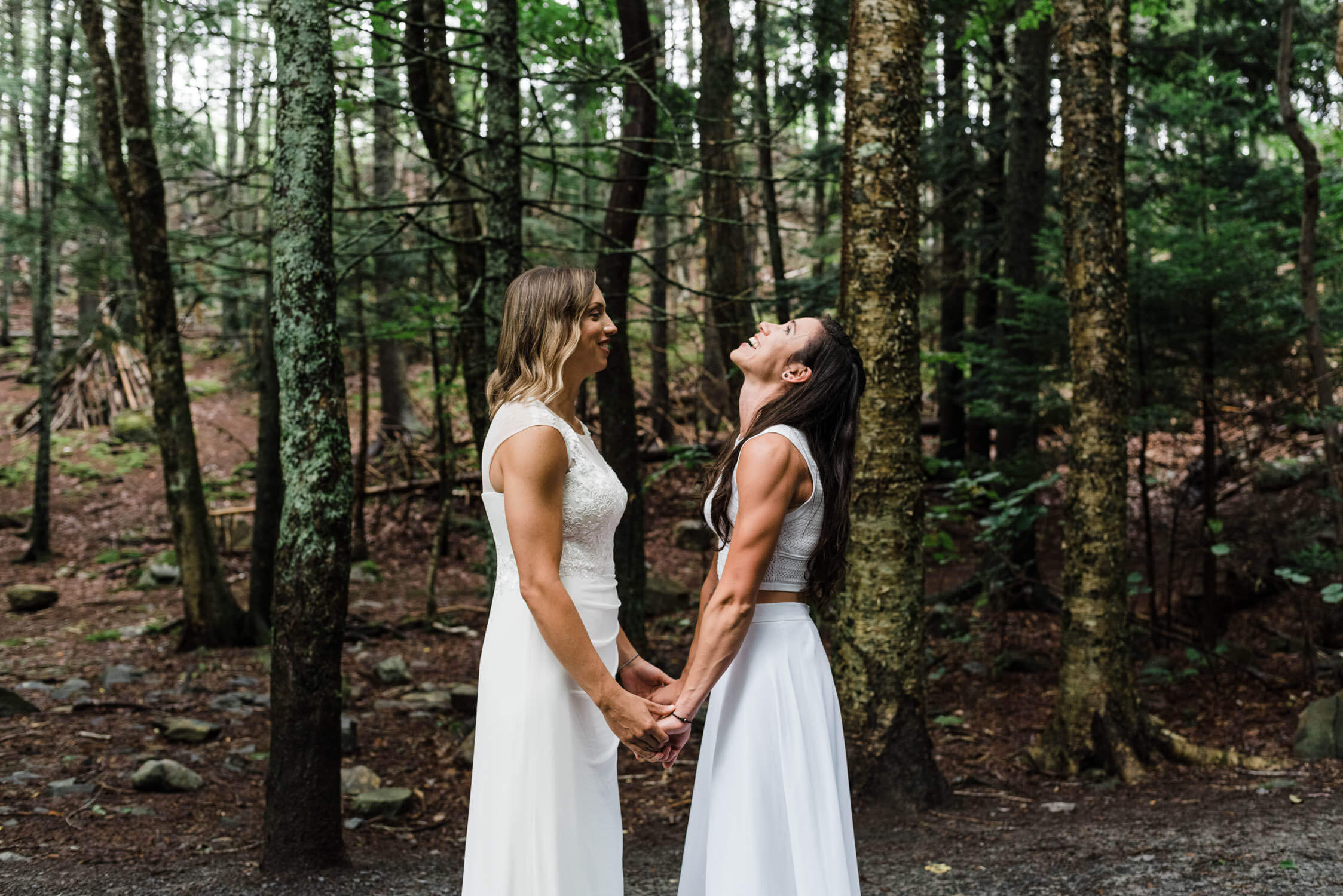 wedding couple holding hands in forest