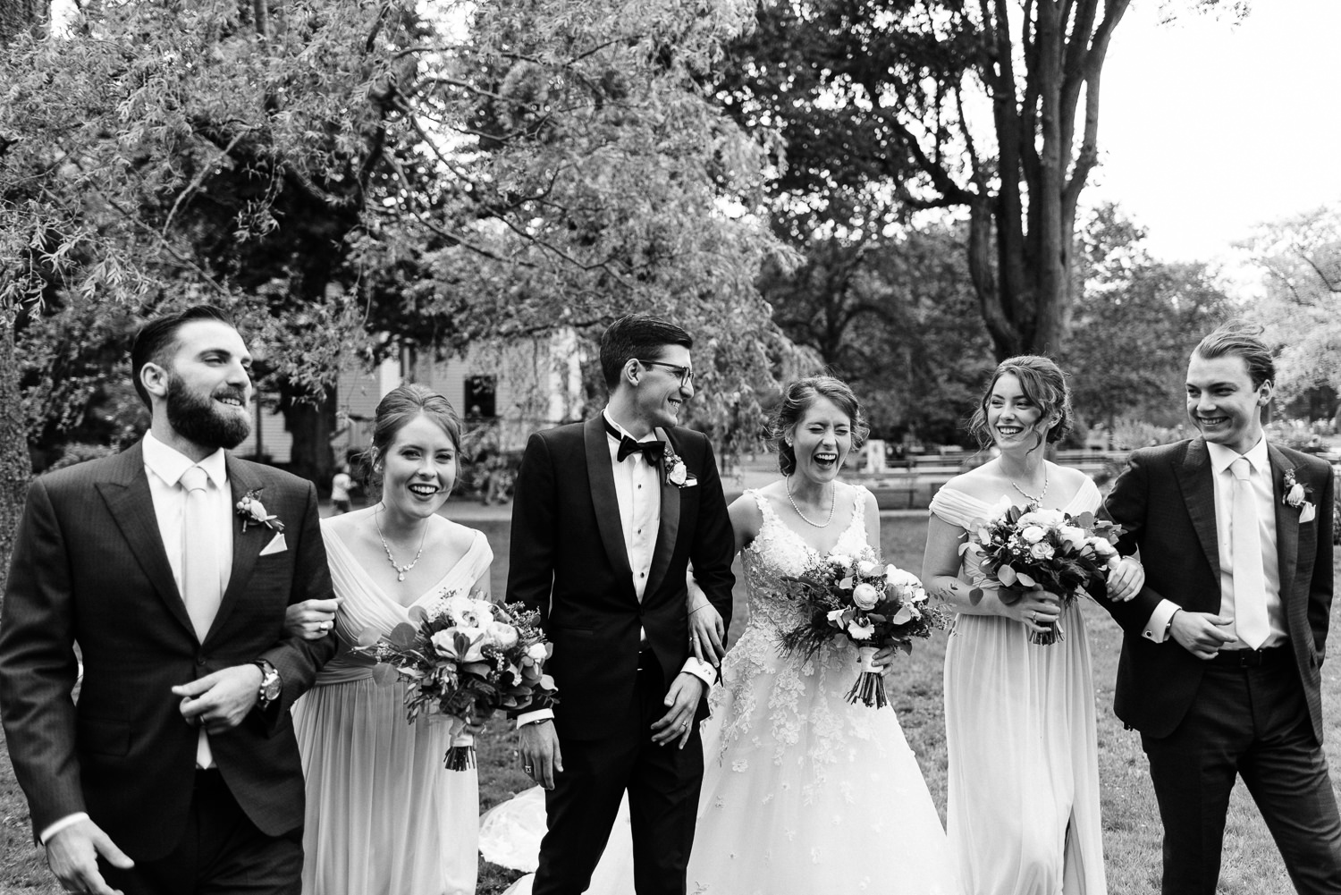 wedding party celebrates with photos at public gardens