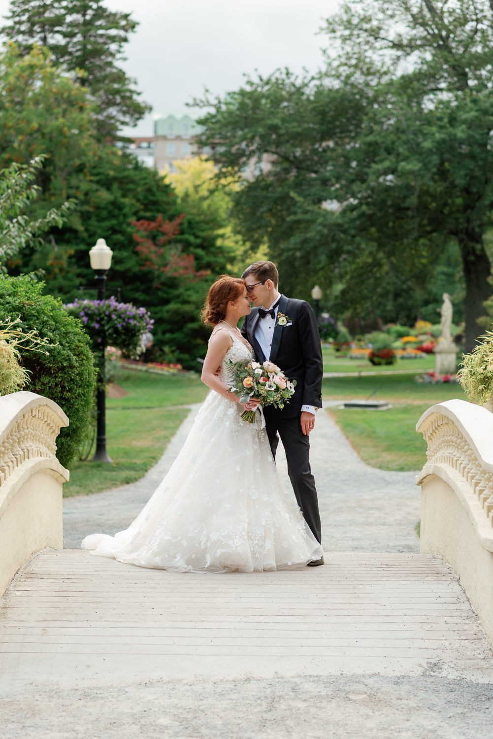 bride and groom pose for photos at halifax public gardens