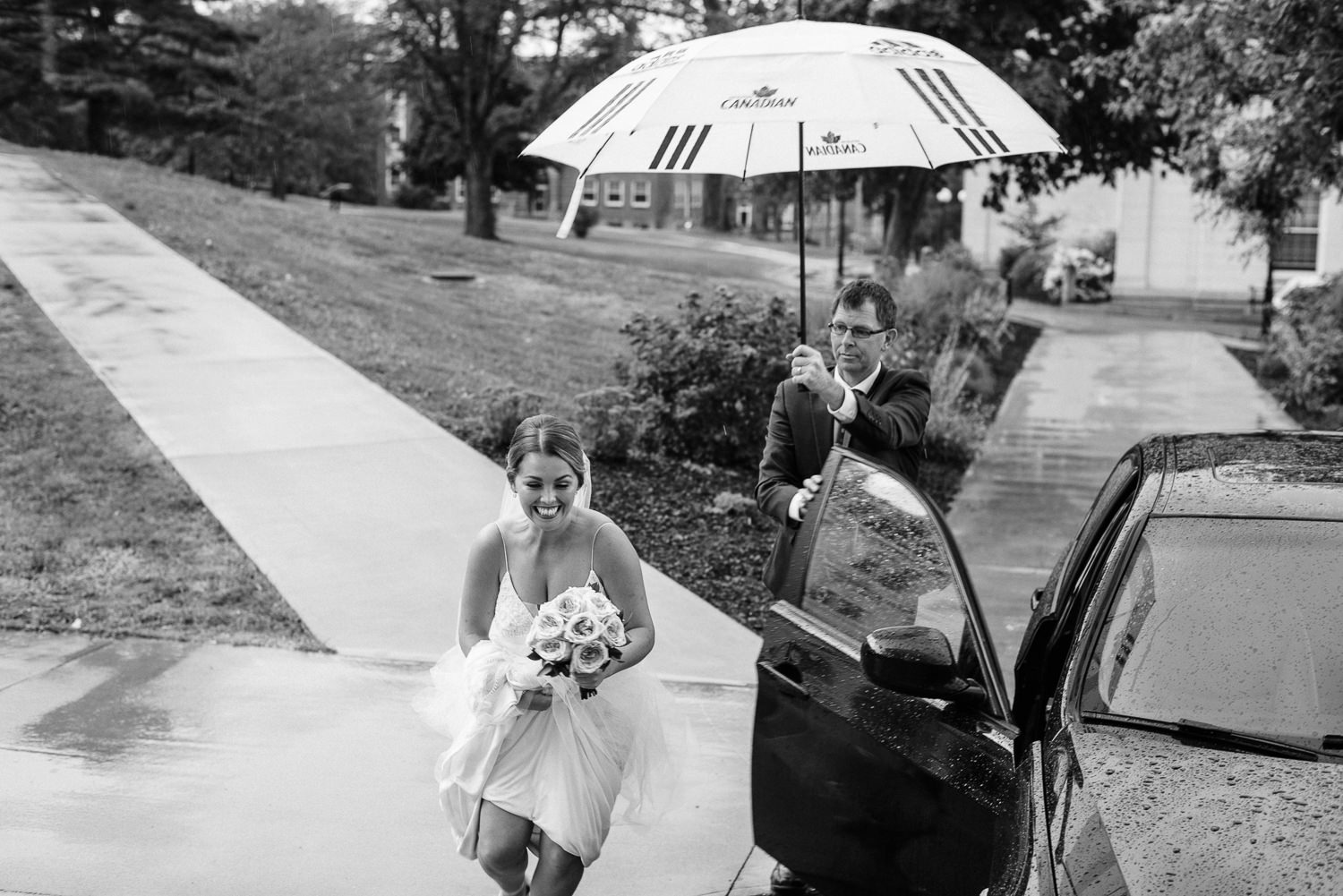 bride runs from car to chapel, trying to avoid the rain