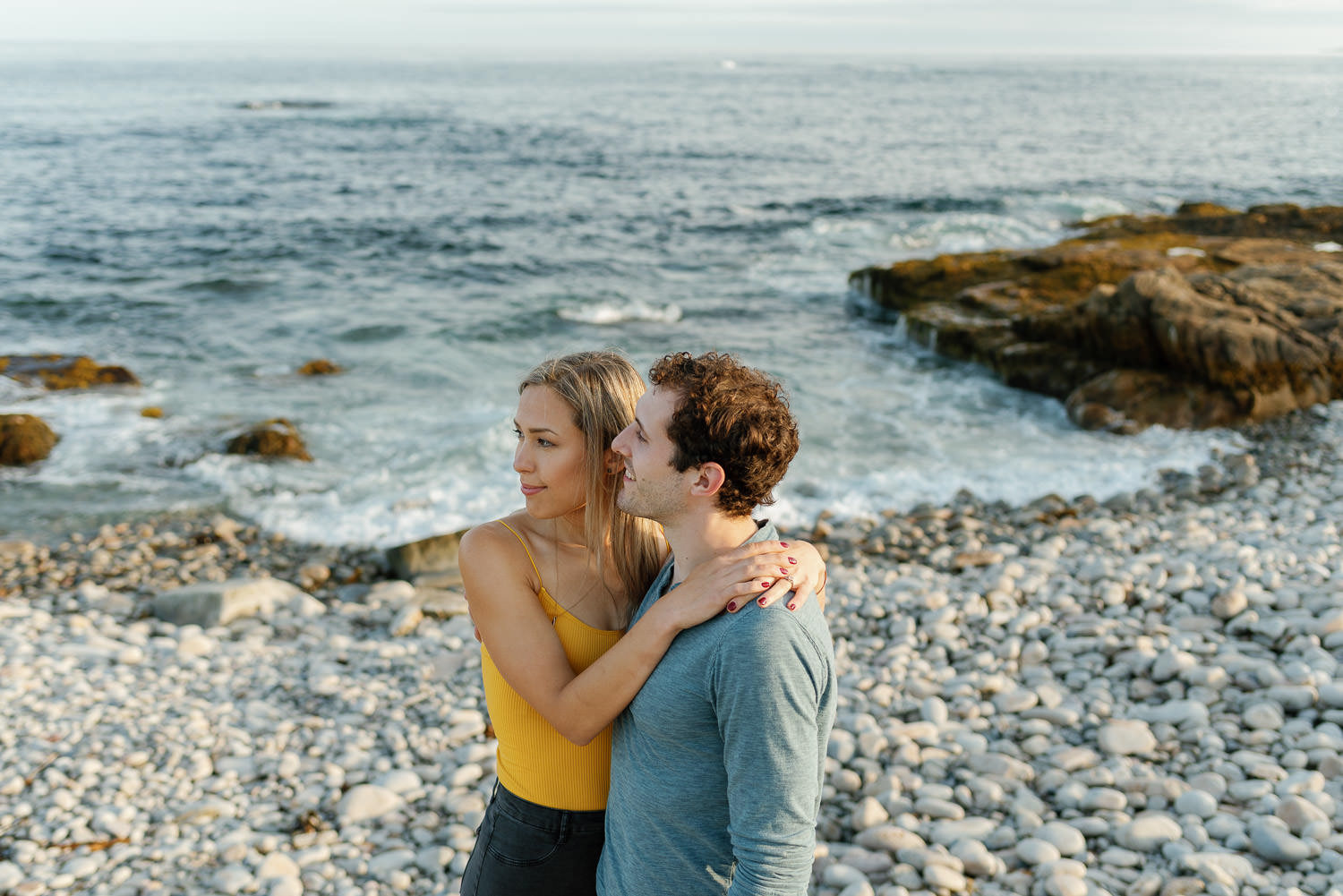 couple pose for engagement session at dunces cove