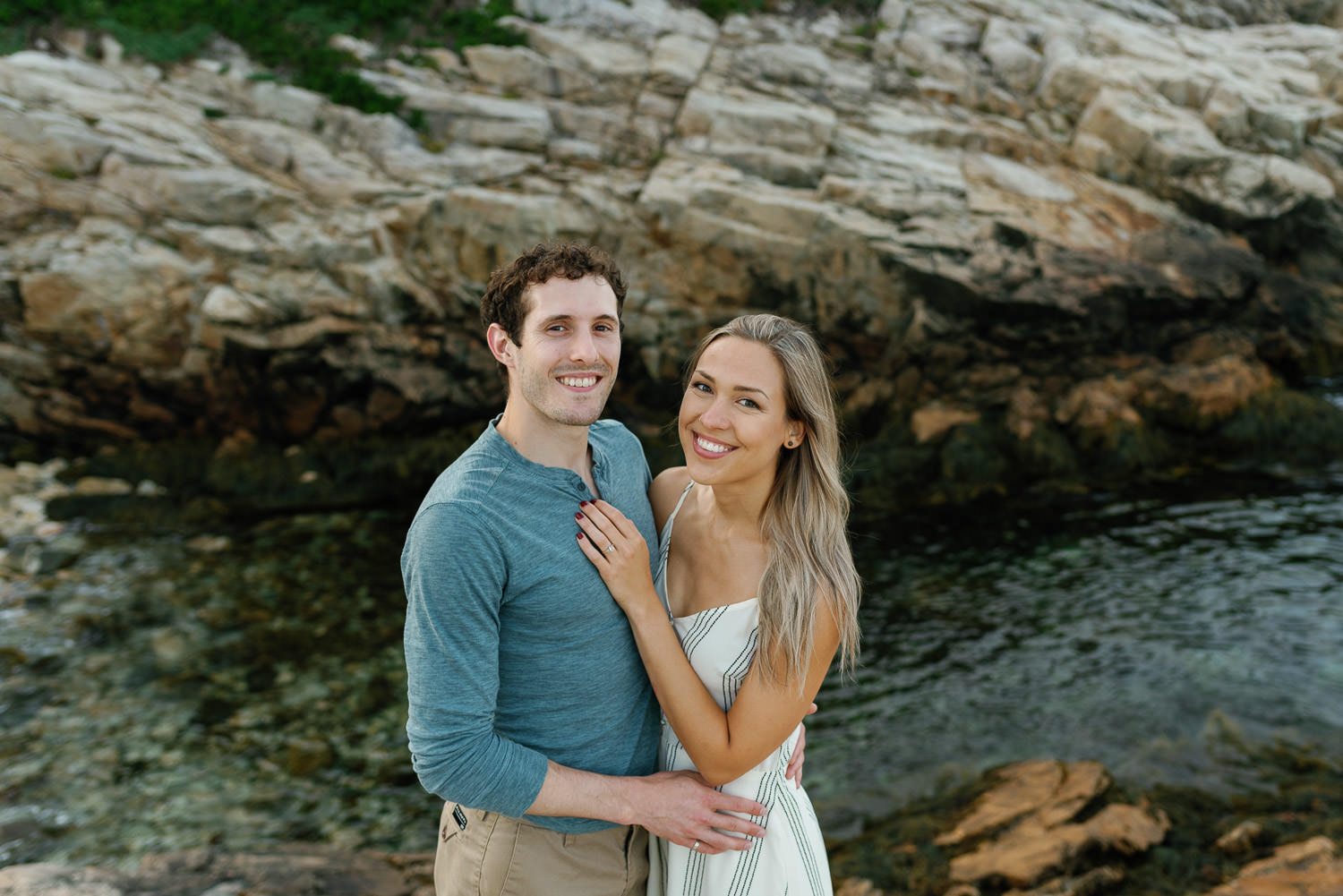 couple pose for engagement session at dunces cove