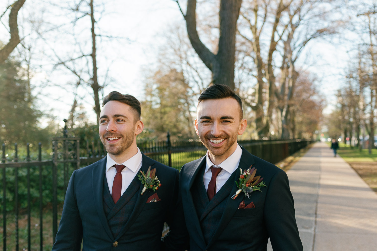 grooms pose for portrait outside public gardens in halifax