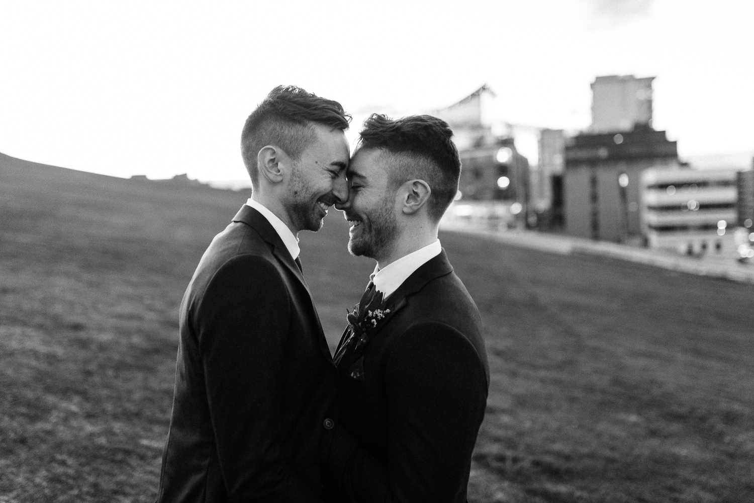 grooms pose for wedding portraits on citadel hill