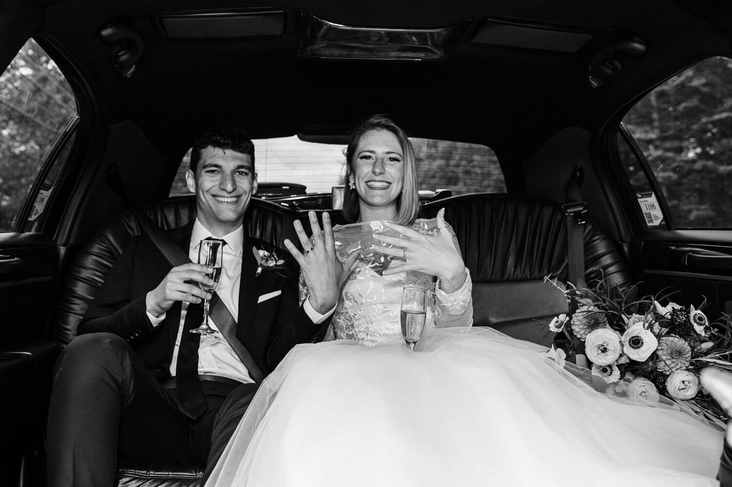 bride and groom in limo on the way to Halifax Club