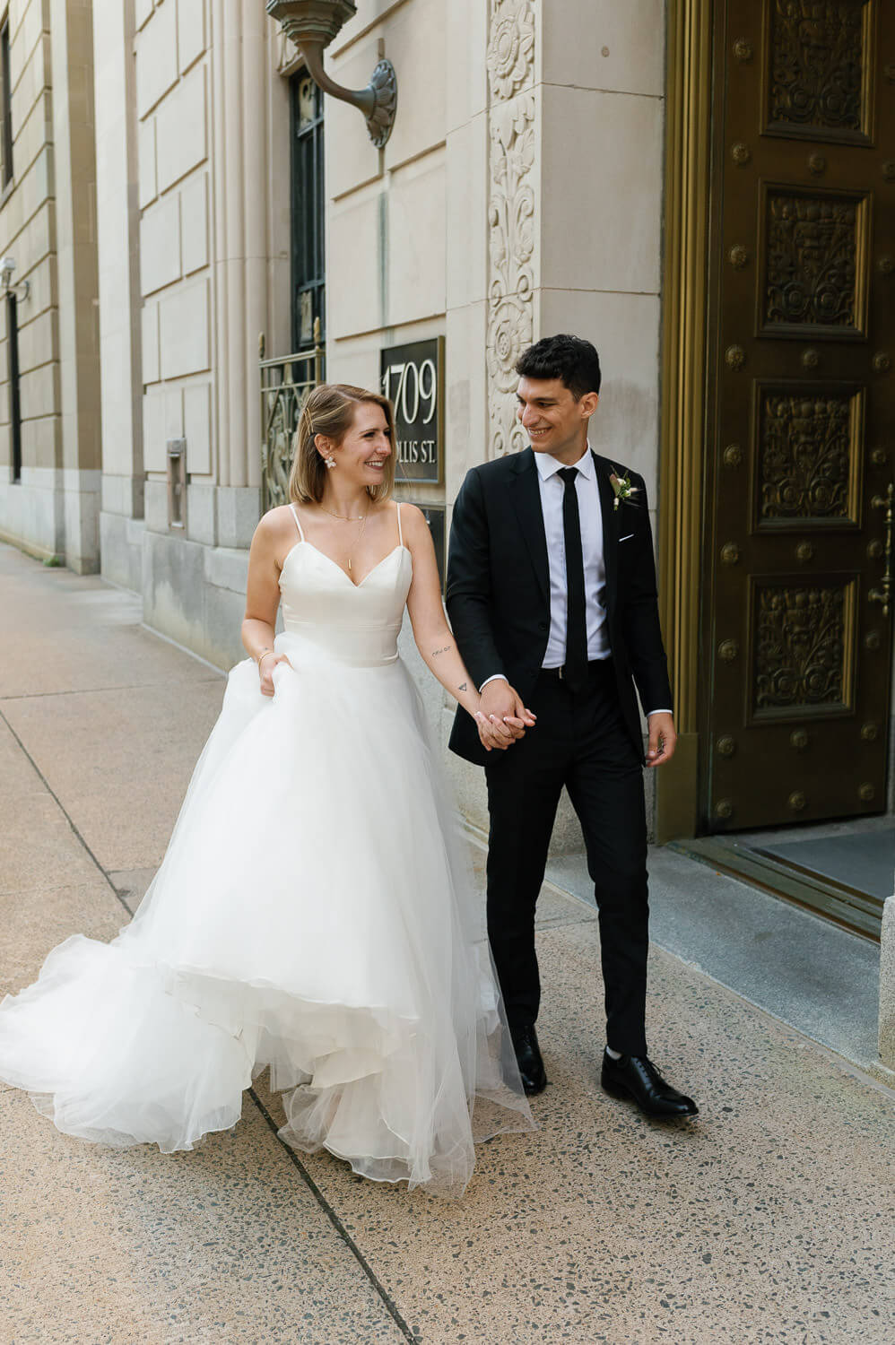 bride and groom walking on Halifax streets
