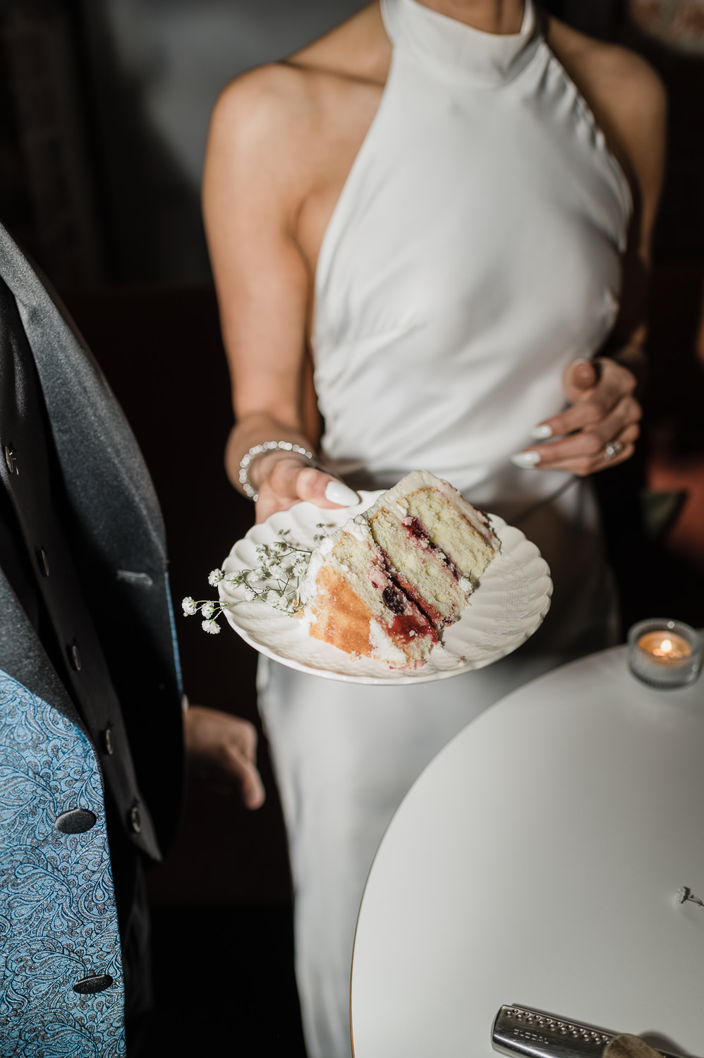 Flash photography of stylish bride and groom cutting cake at Anemone Dining.