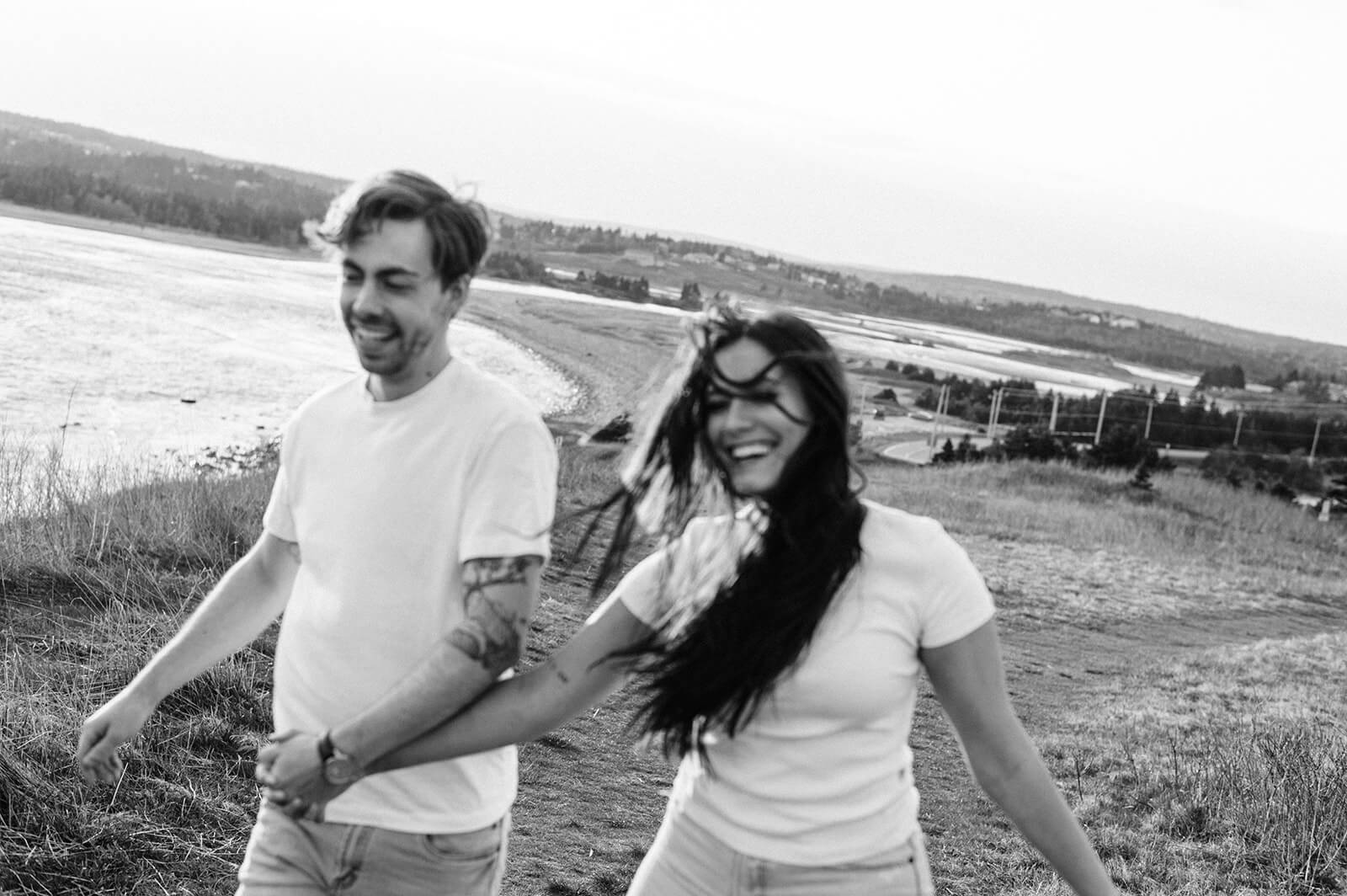 couple laughing at lawrencetown beach engagement session