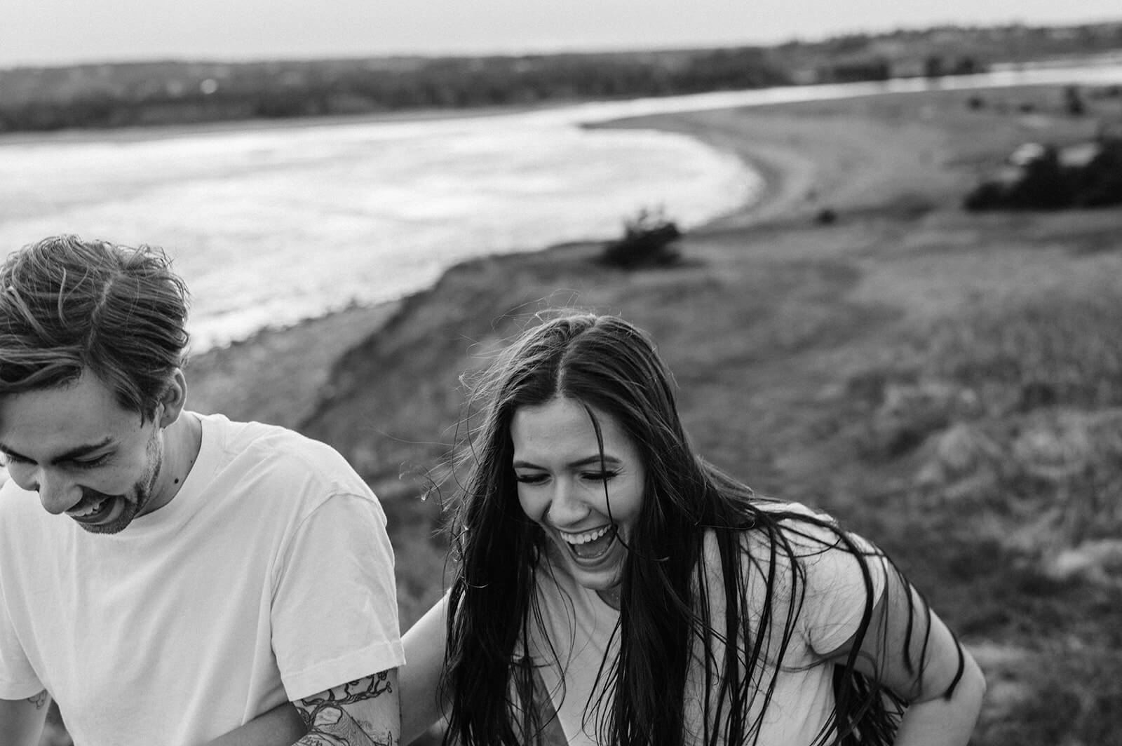 couple laughing at lawrencetown beach engagement session