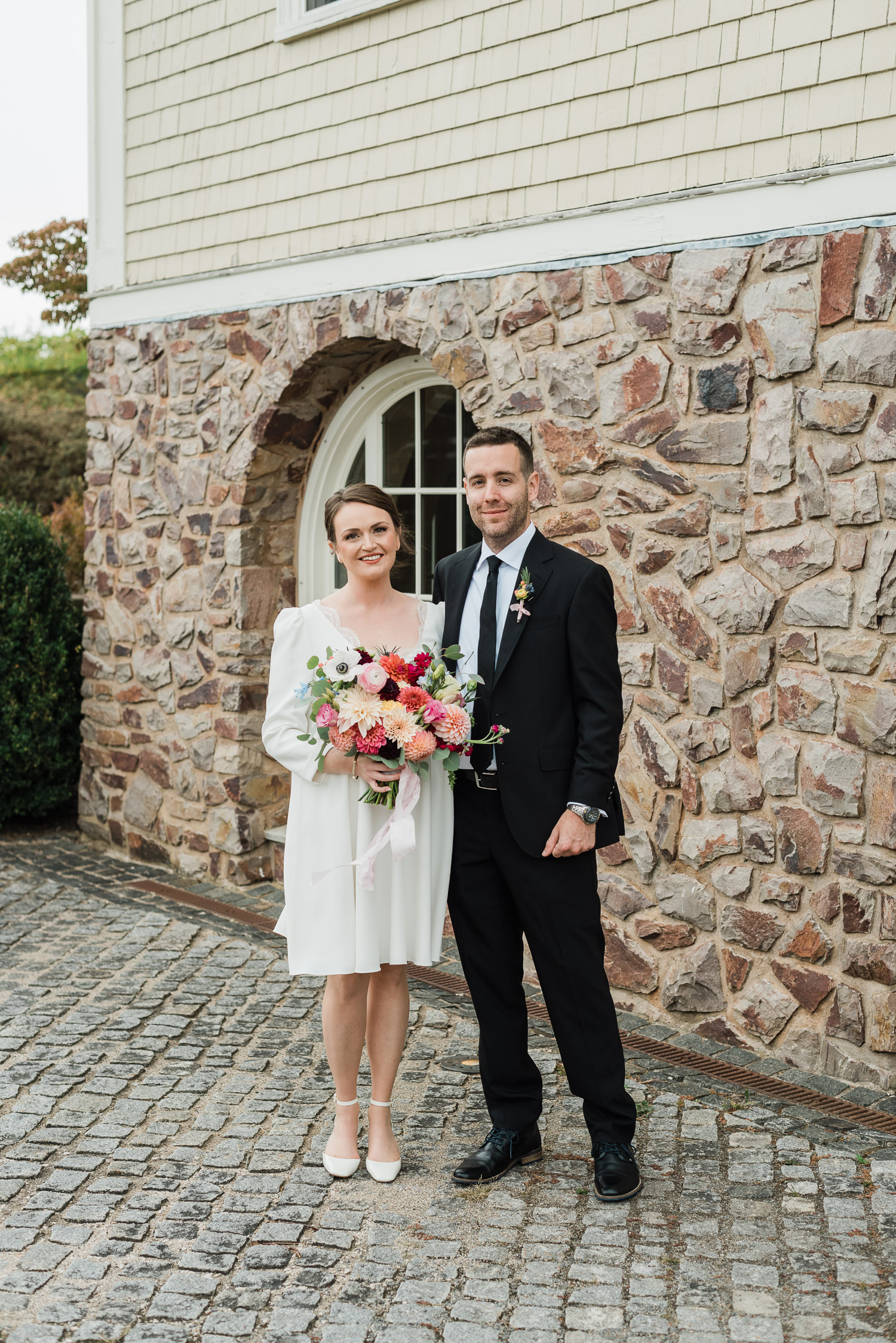 Bride and groom pose at Grand Pré Winery wedding