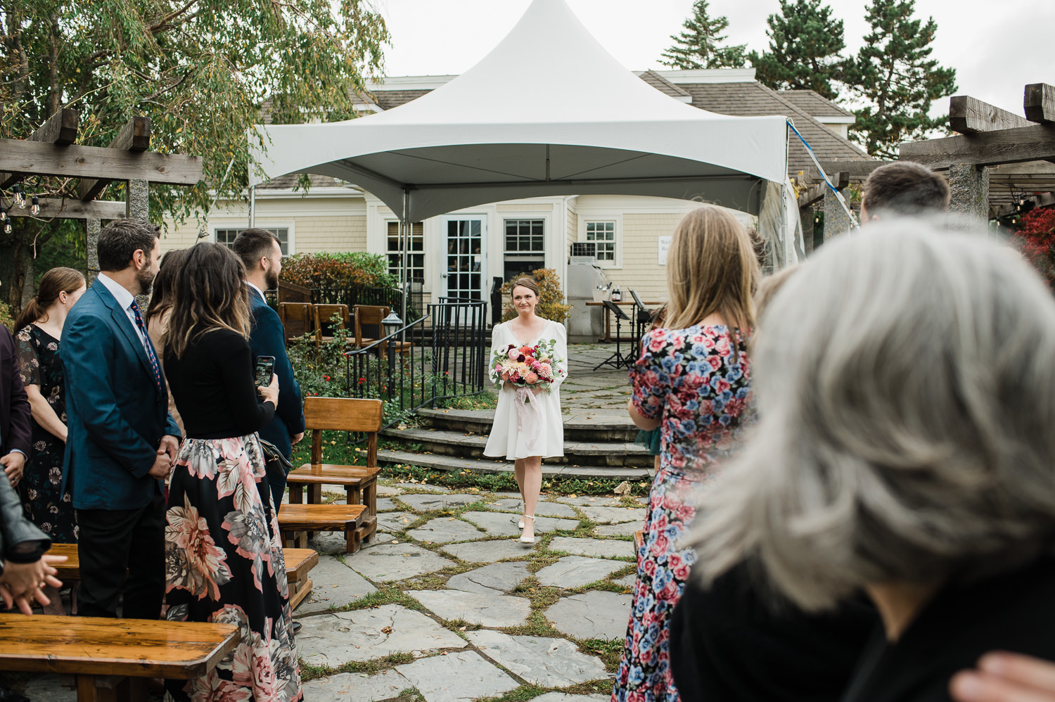 Bride walks down the ceremony aisle for Grand Pré Winery wedding