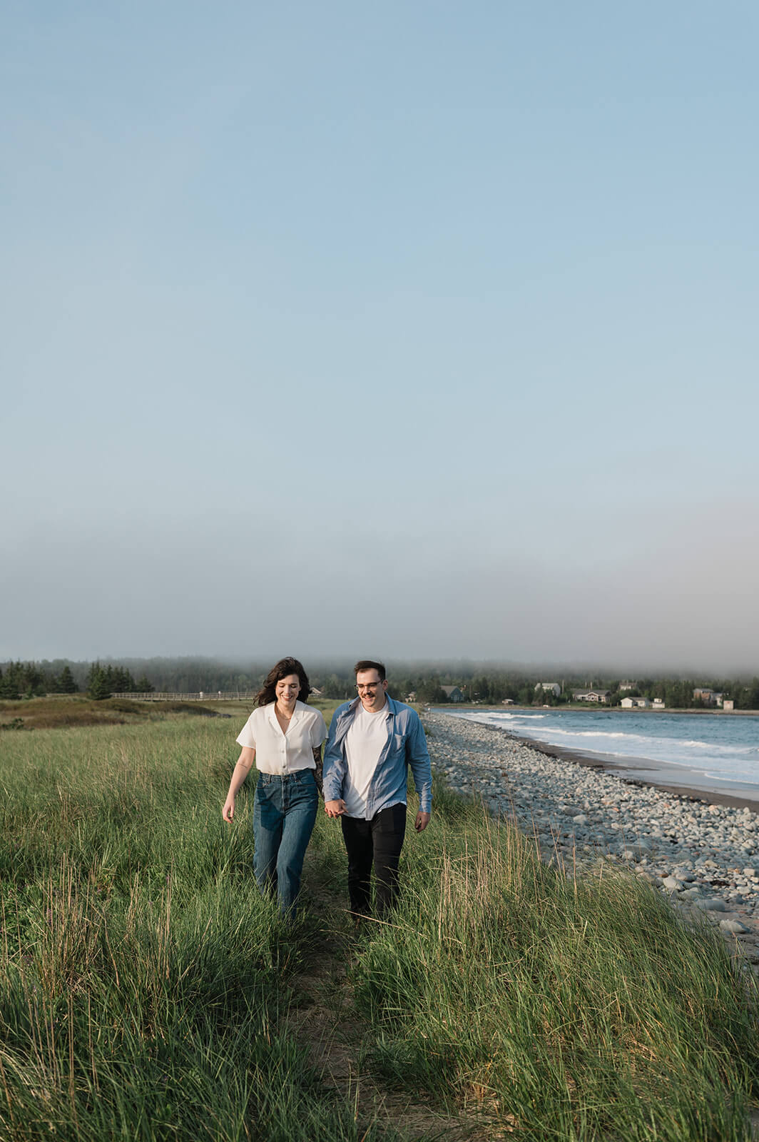 Couple holdings hands on Rainbow Haven beach