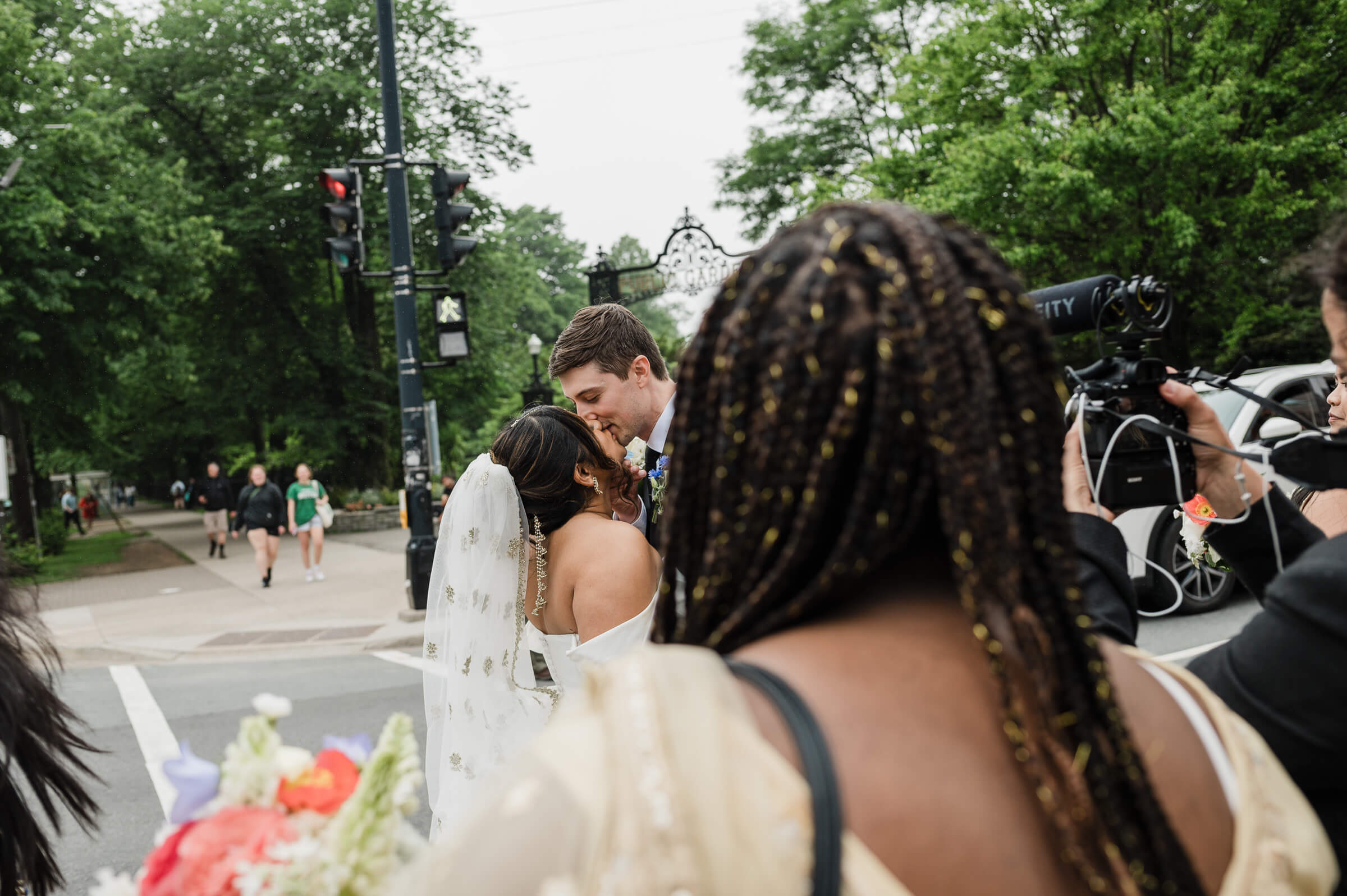 Wedding couple and friends walk on Spring Garden Road in Halifax