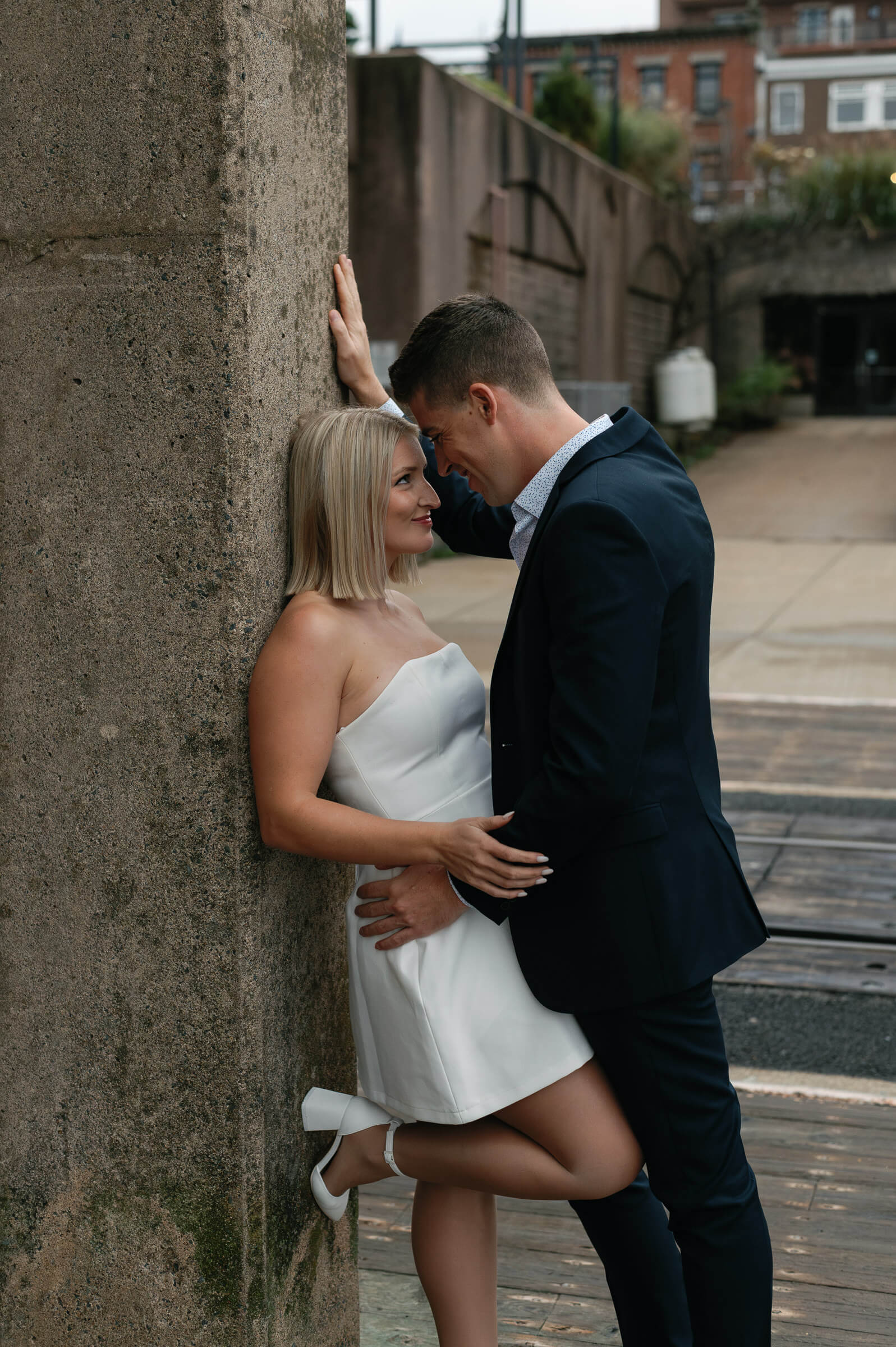 couple pose for engagement photos in downtown dartmouth