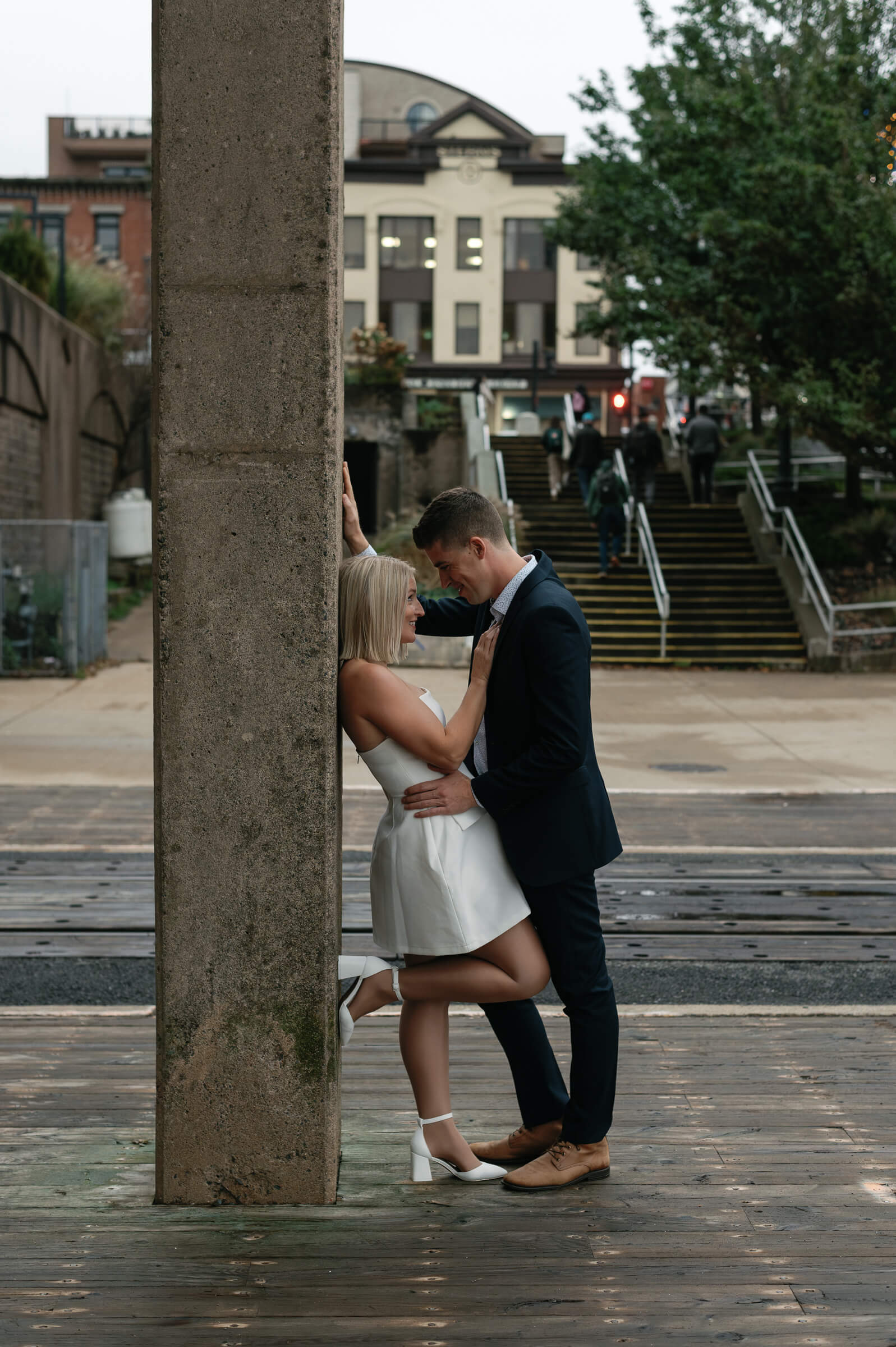 couple pose for engagement photos in downtown dartmouth