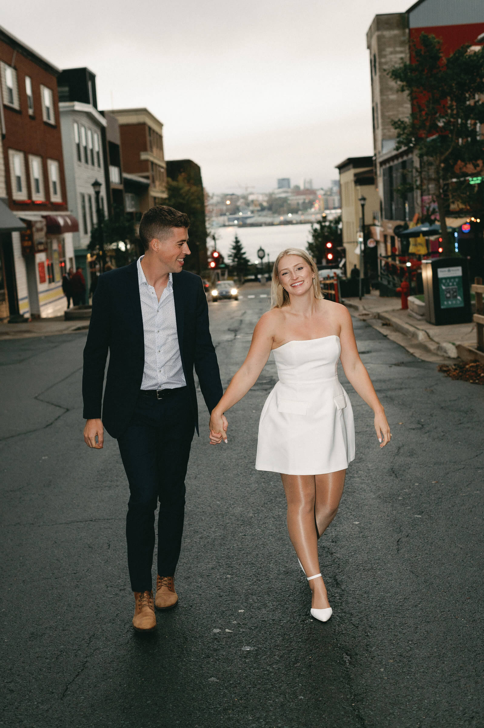 couple pose for engagement photos in downtown dartmouth