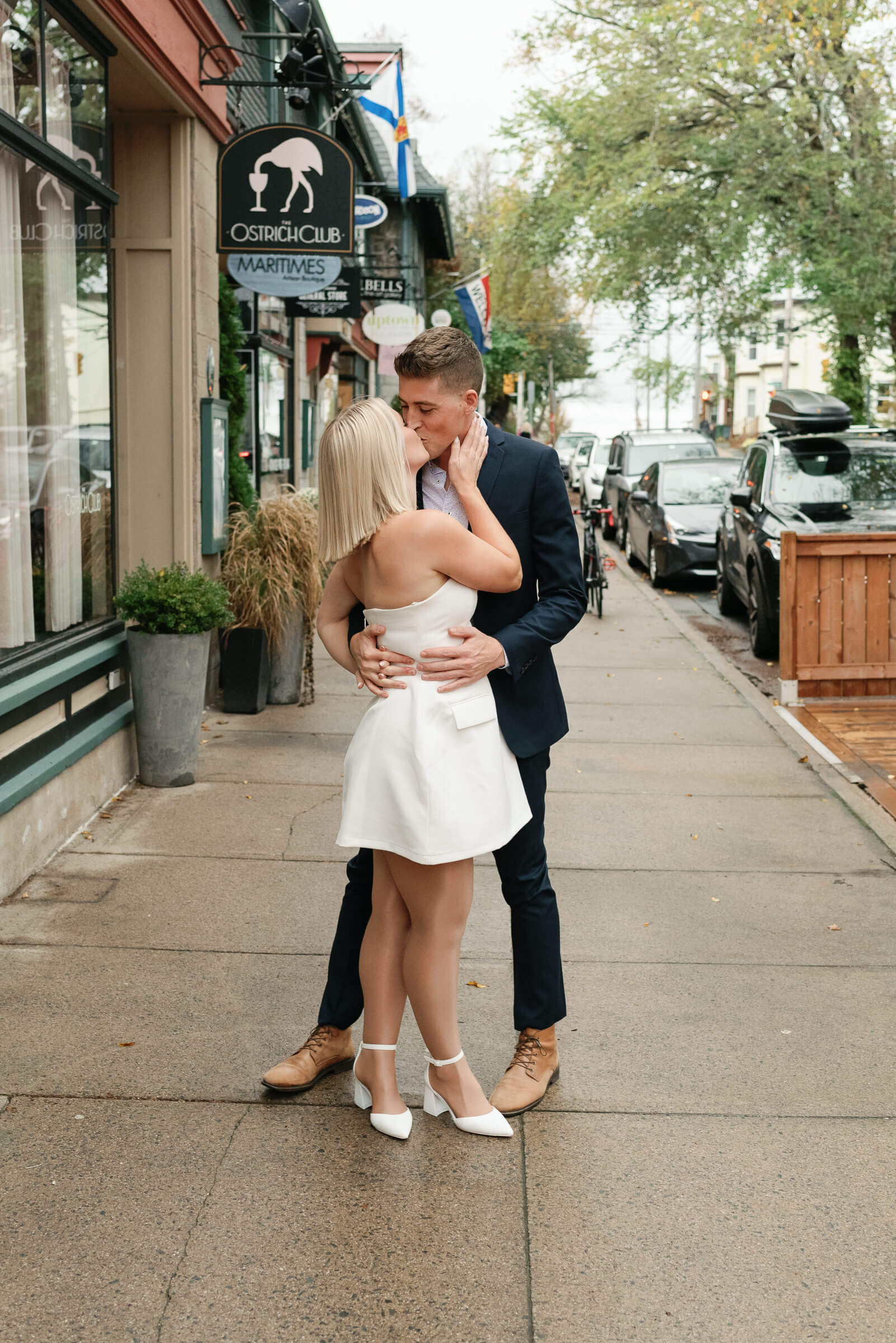 couple pose for engagement photos in the halifax hydrostone