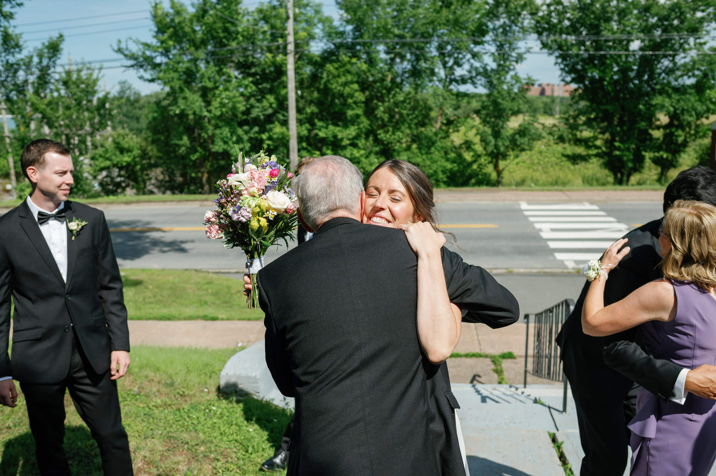 bride hugs father after wedding