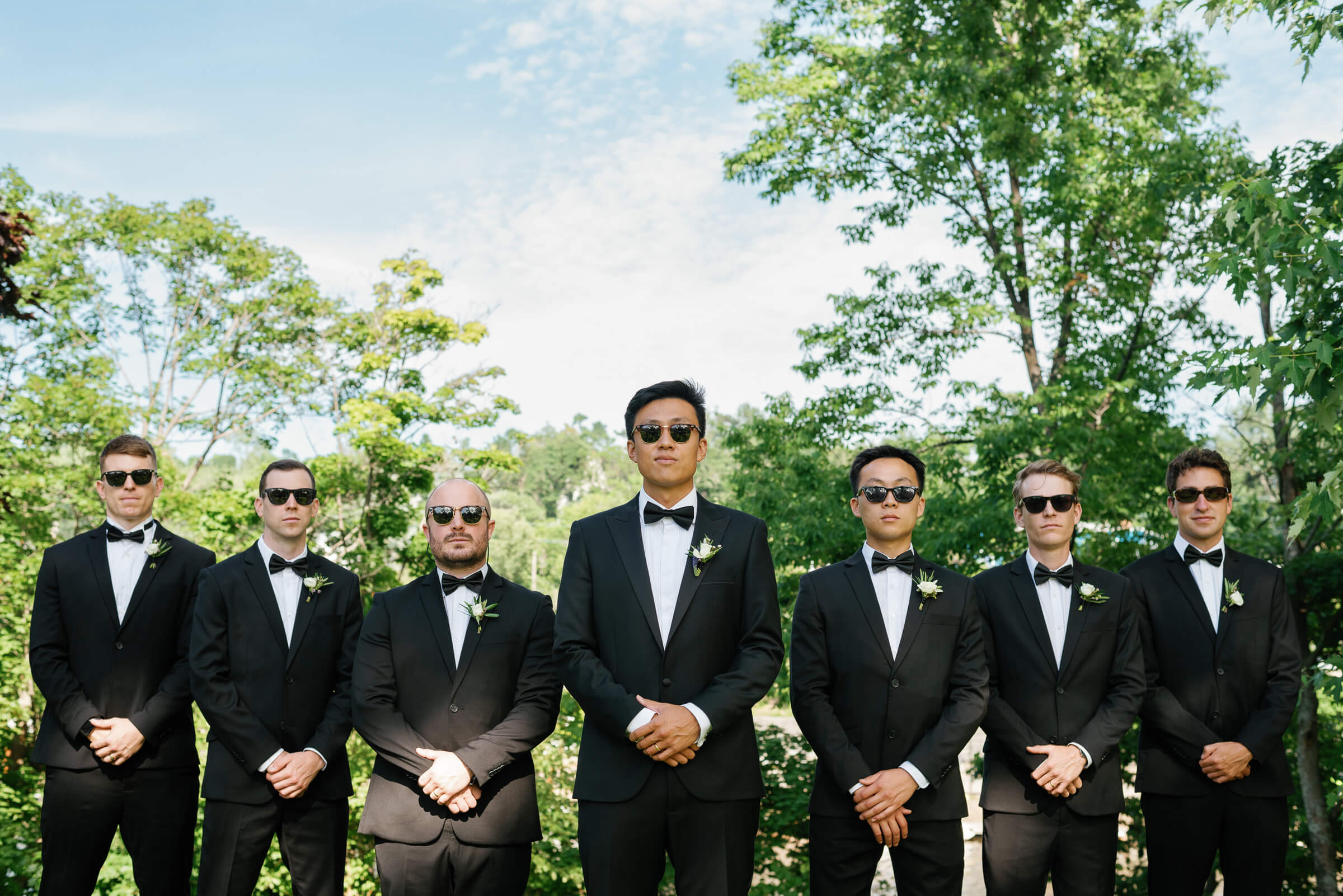 groomsmen pose for photos in new glasgow park