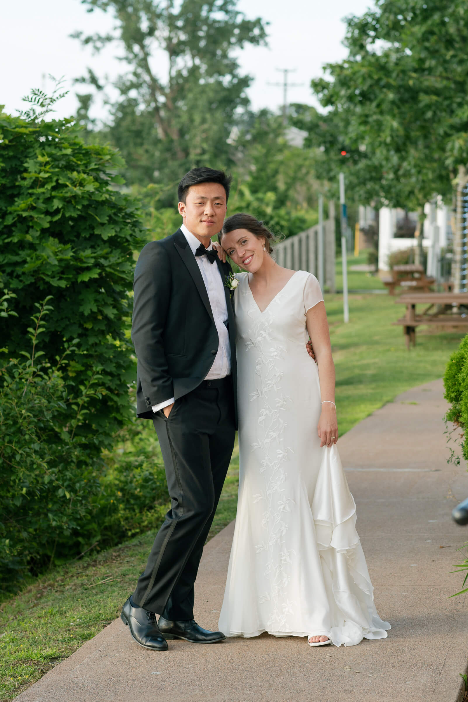 bride and groom pose for photos in new glasgow park
