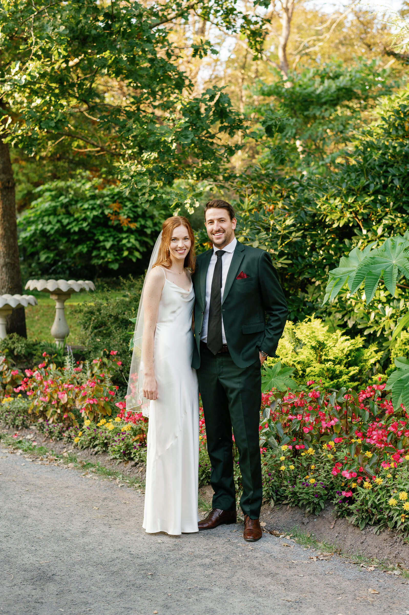 bride and groom smile for wedding portraits in halifax public gardens