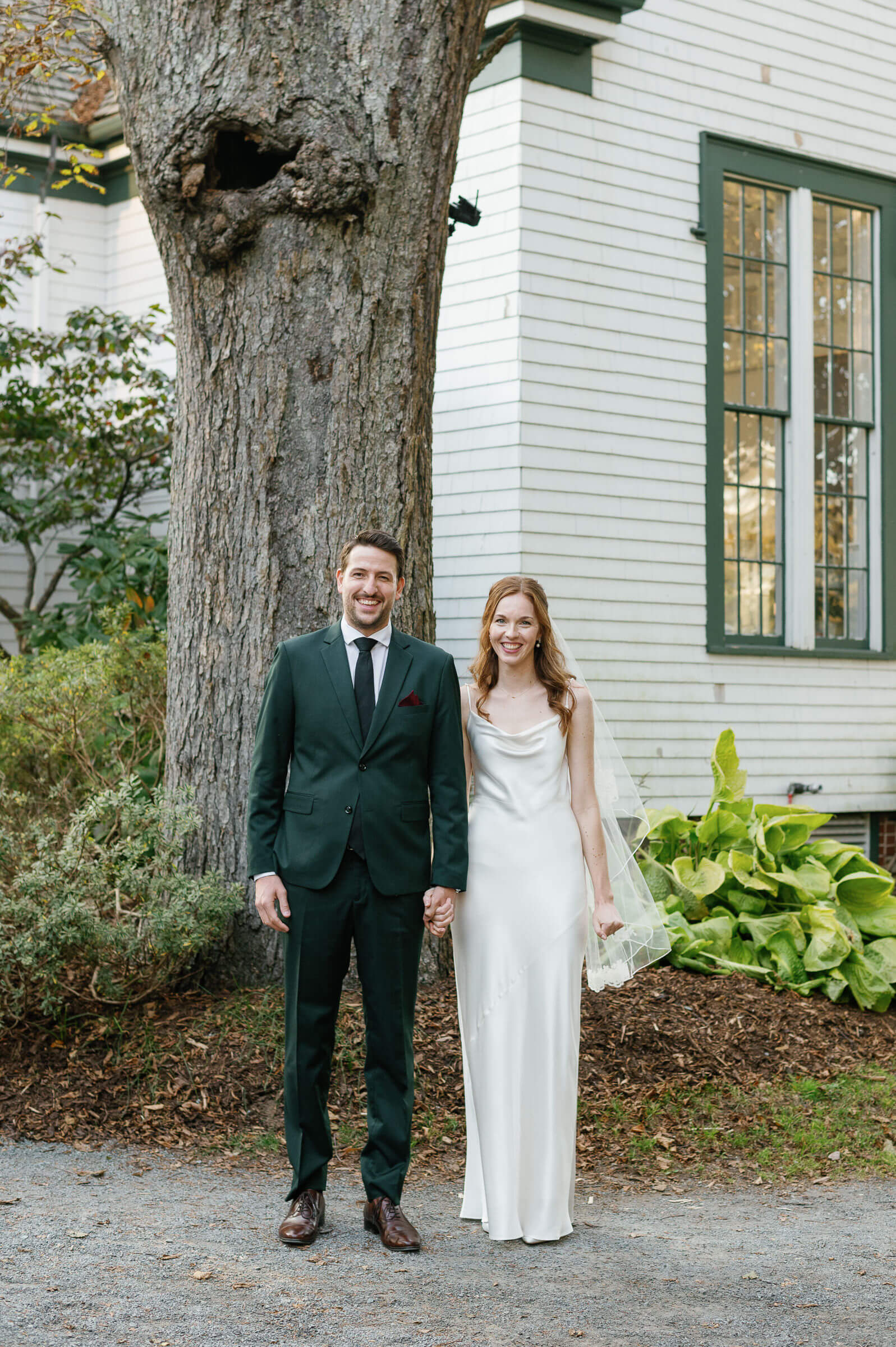 bride and groom smile for portrait at the halifax public gardens