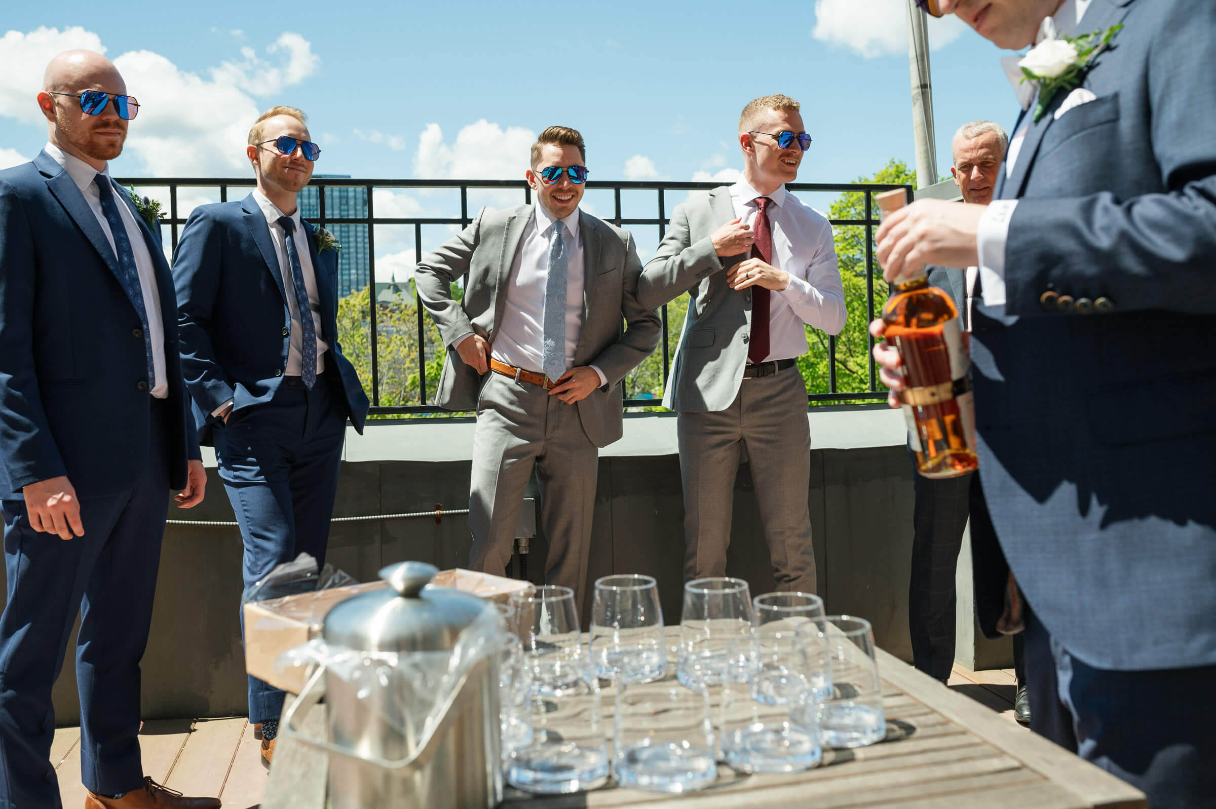 groomsmen enjoy a drink on the deck of the westin hotel