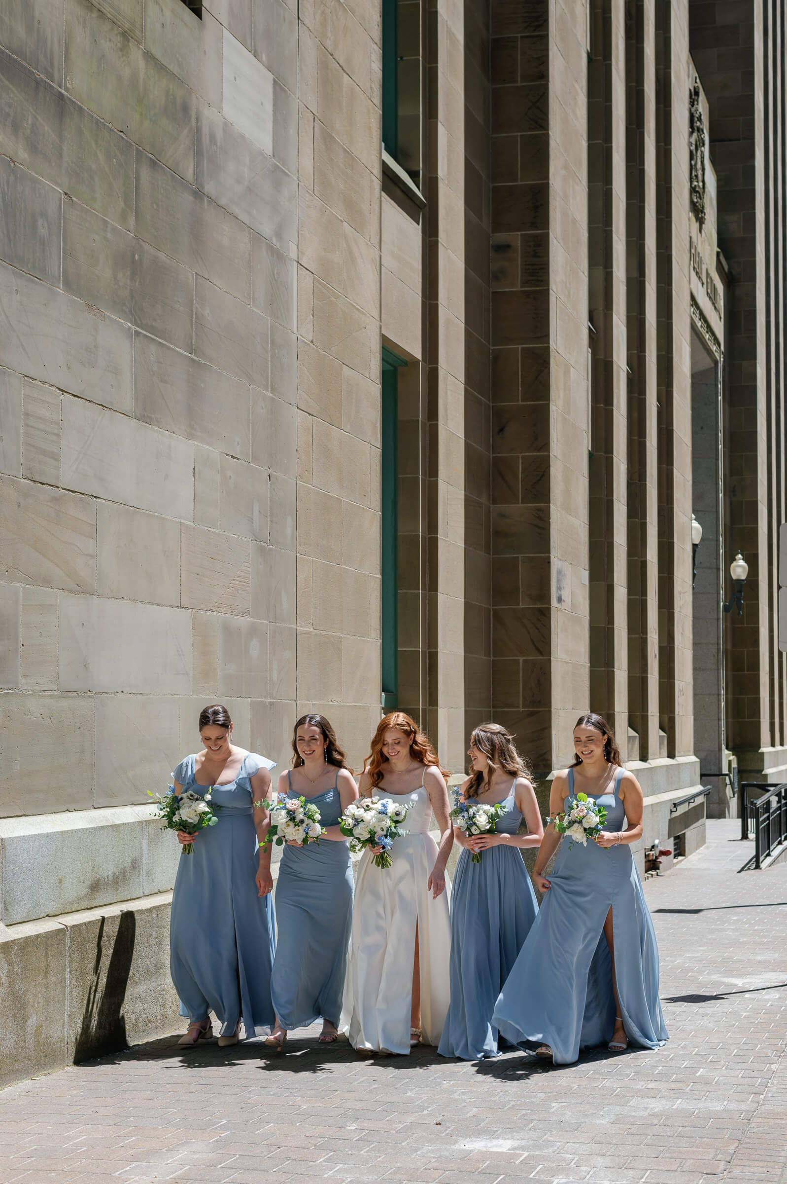 bride and bridesmaids walk in downtown halifax