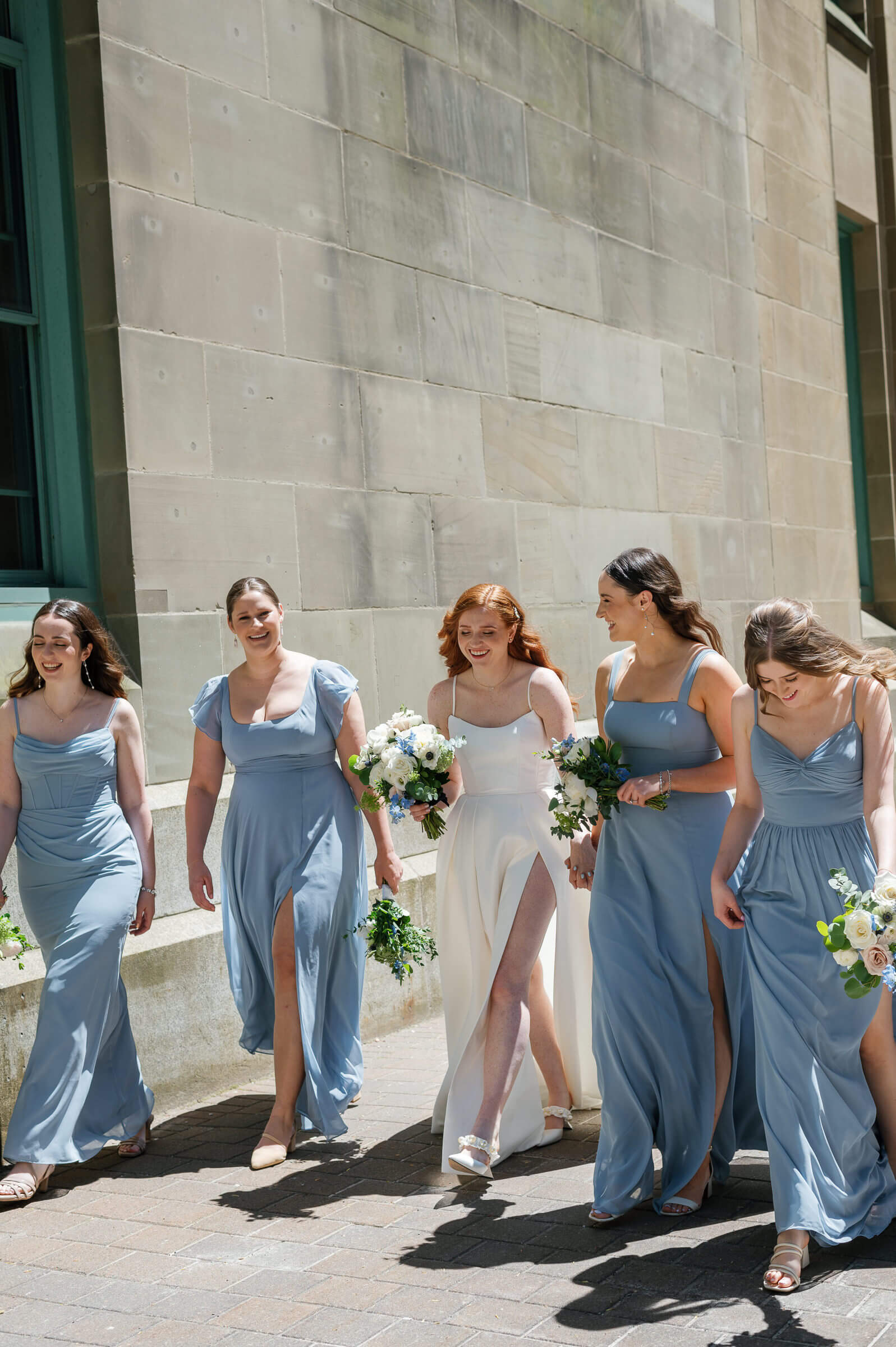 bride and bridesmaids walk in downtown halifax