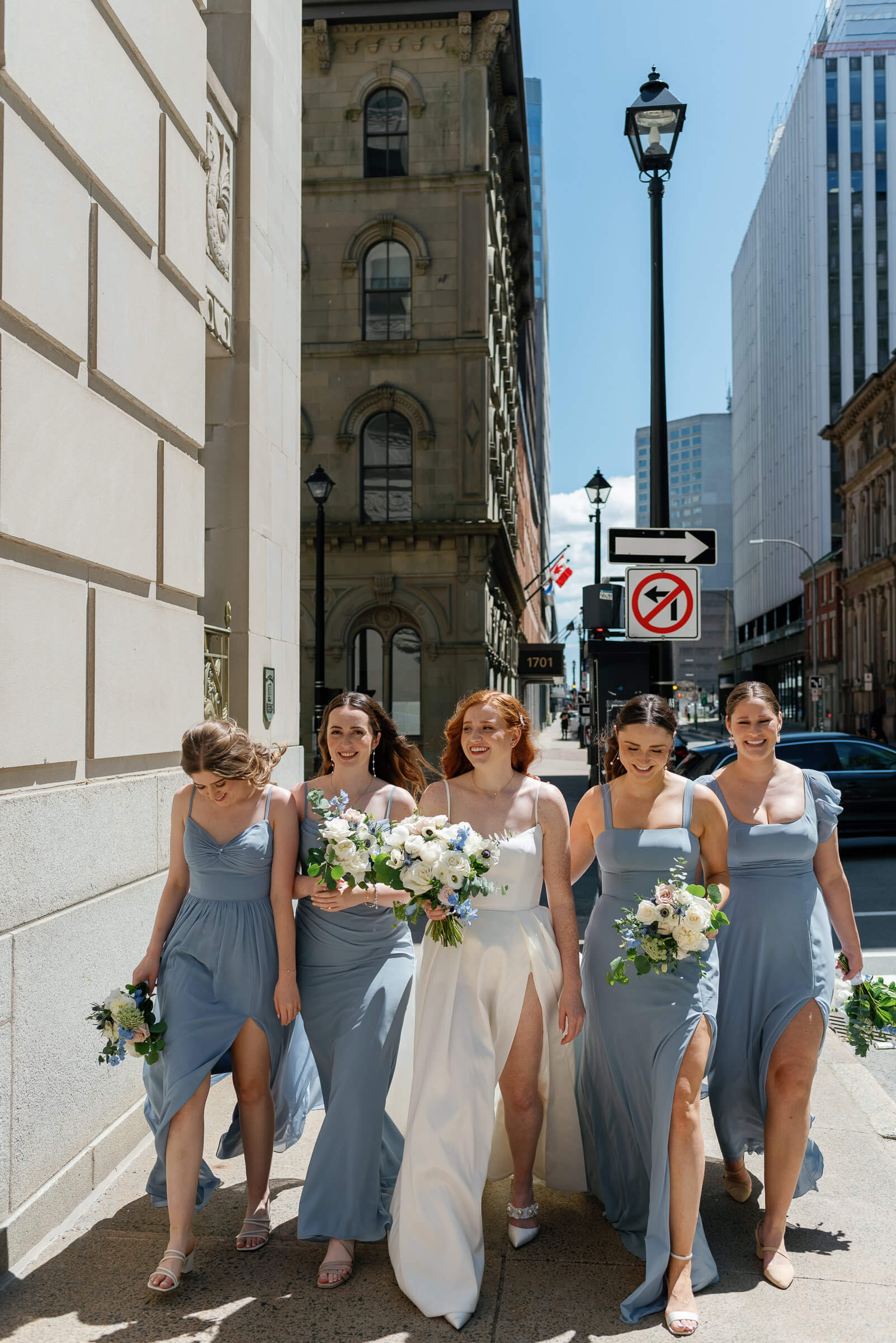 bride and bridesmaids walk in downtown halifax