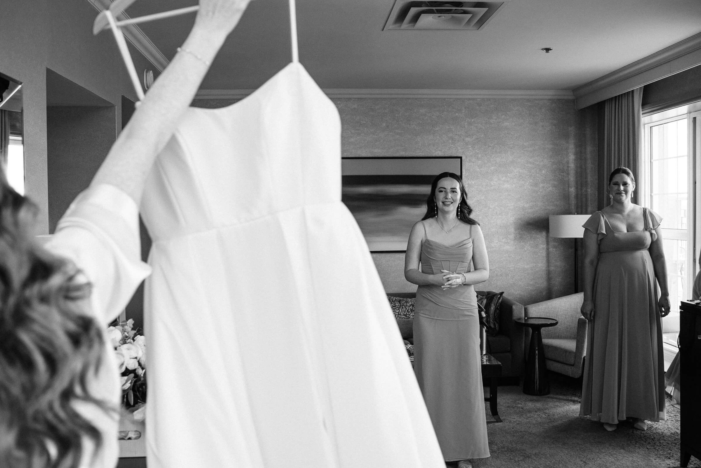 bride shows her dress to bridesmaids at westin hotel wedding