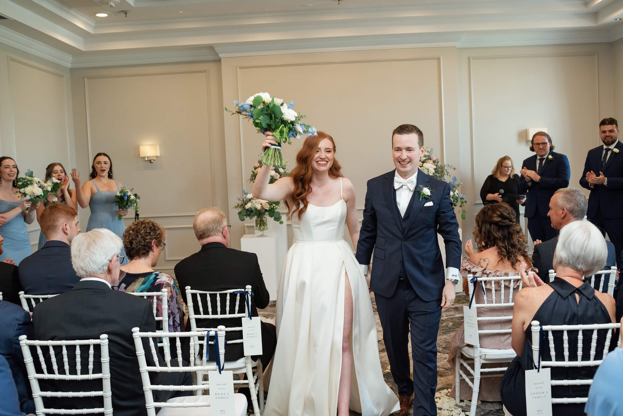 bride and groom hold hands as the exit ceremony at westin nova scotia wedding