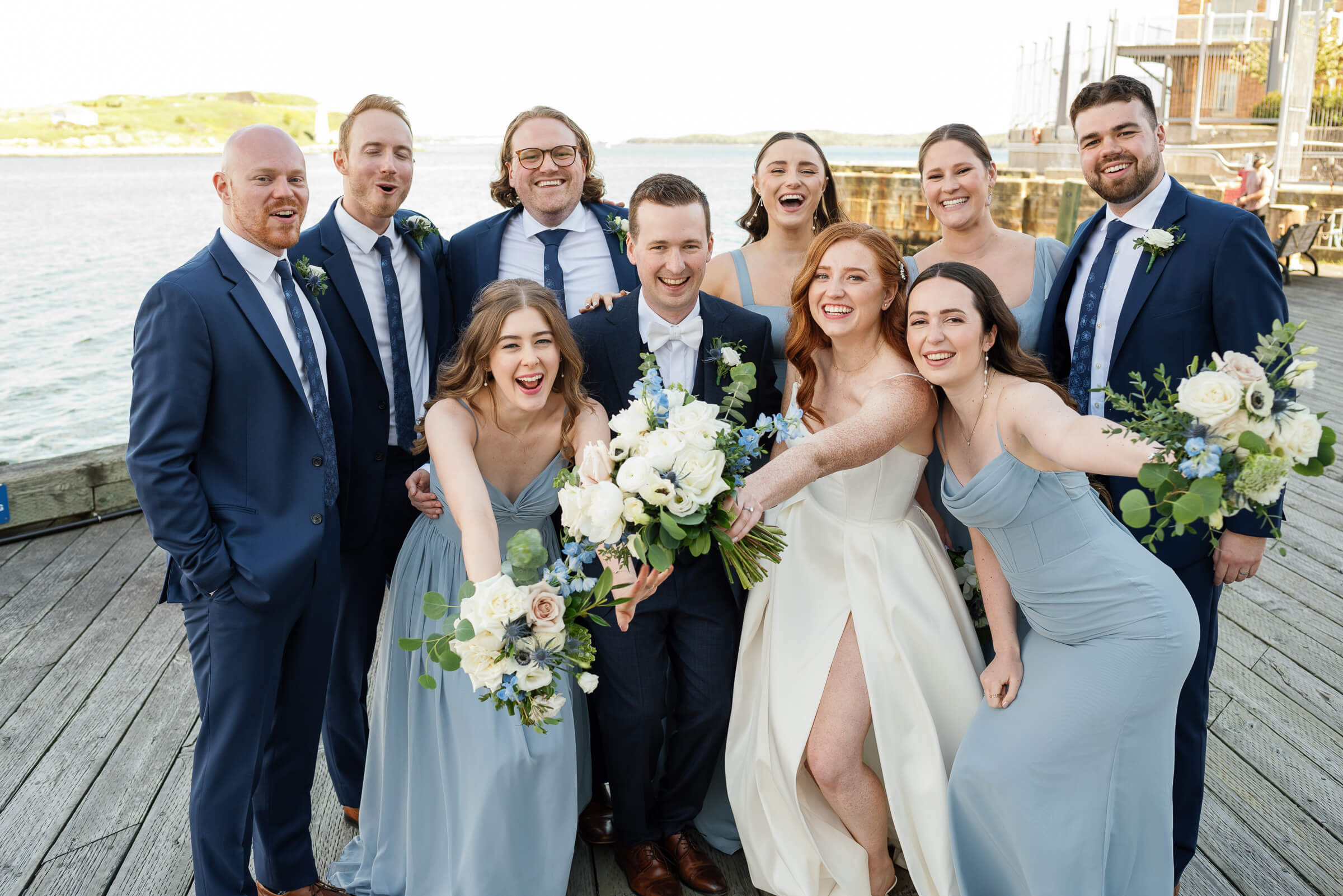 bridal party poses for group photo along the halifax waterfront