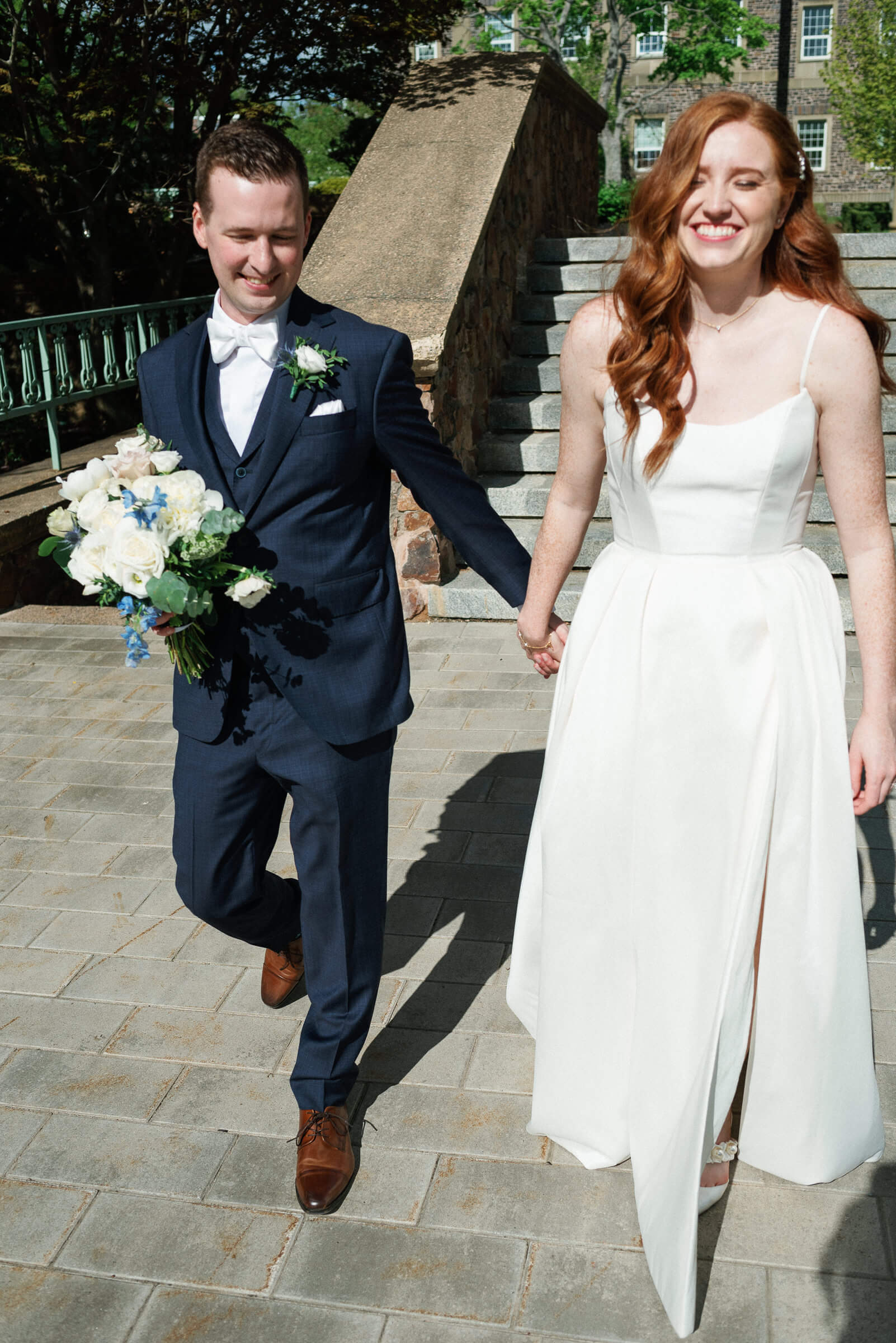 bride and groom pose for portraits at the king's college campus