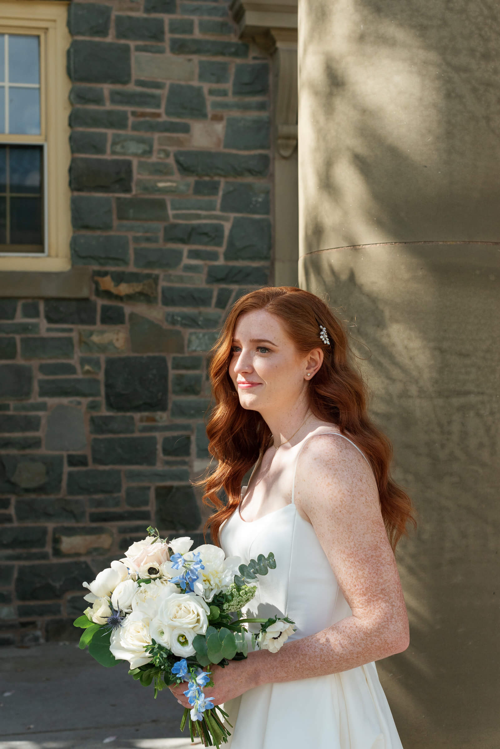 bride poses for portraits at the king's college campus