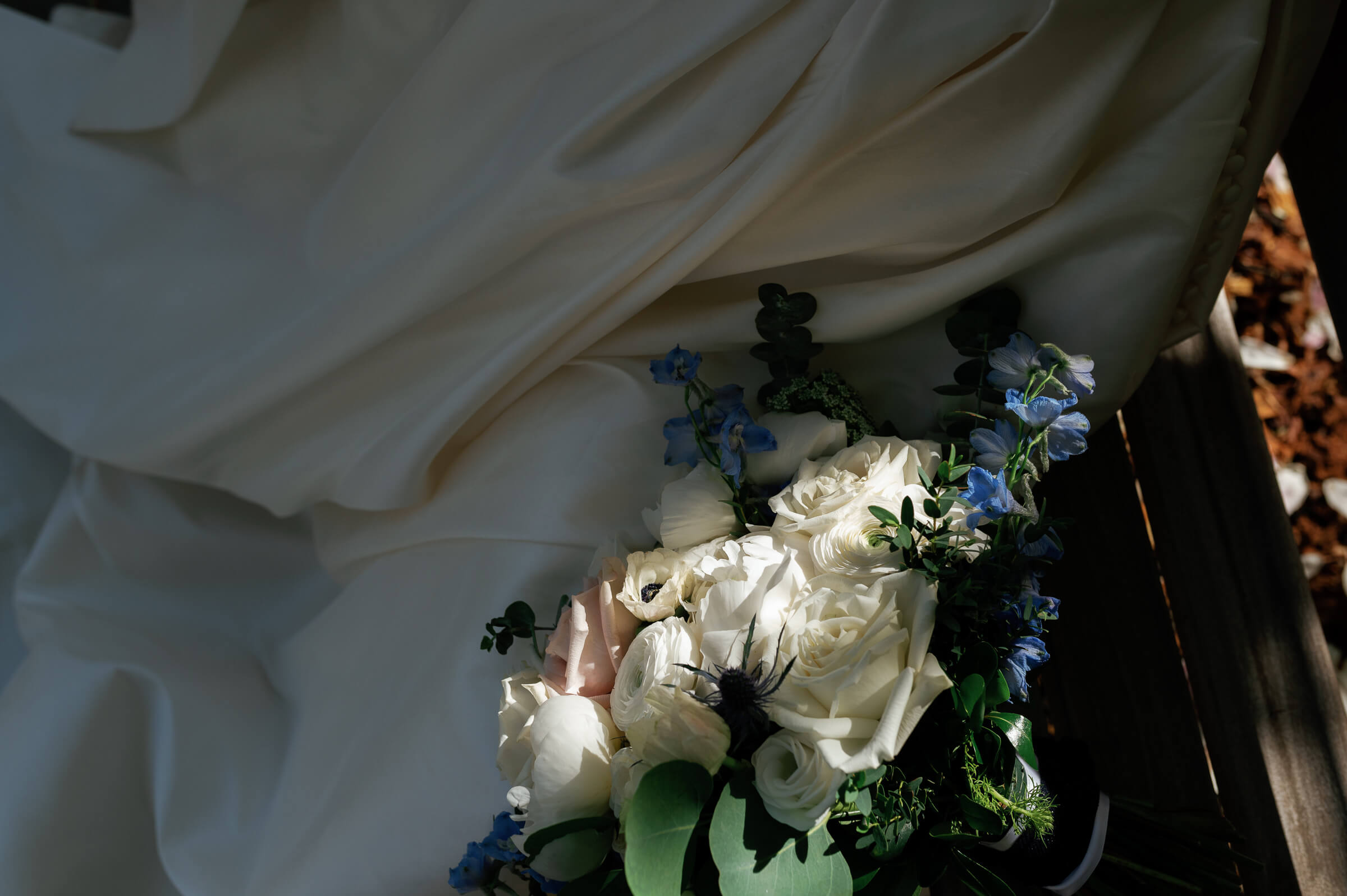 bride's flowers on a bench with a sliver of sunlight shining on them