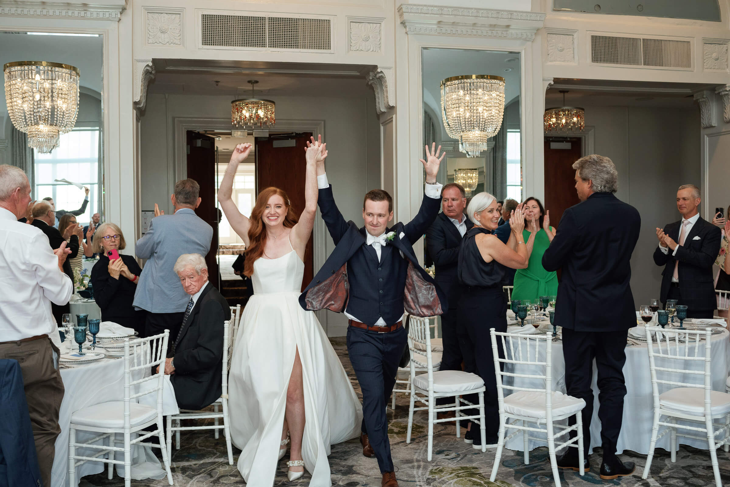 bride and grooms enter reception at westin nova scotia while guests applaud 