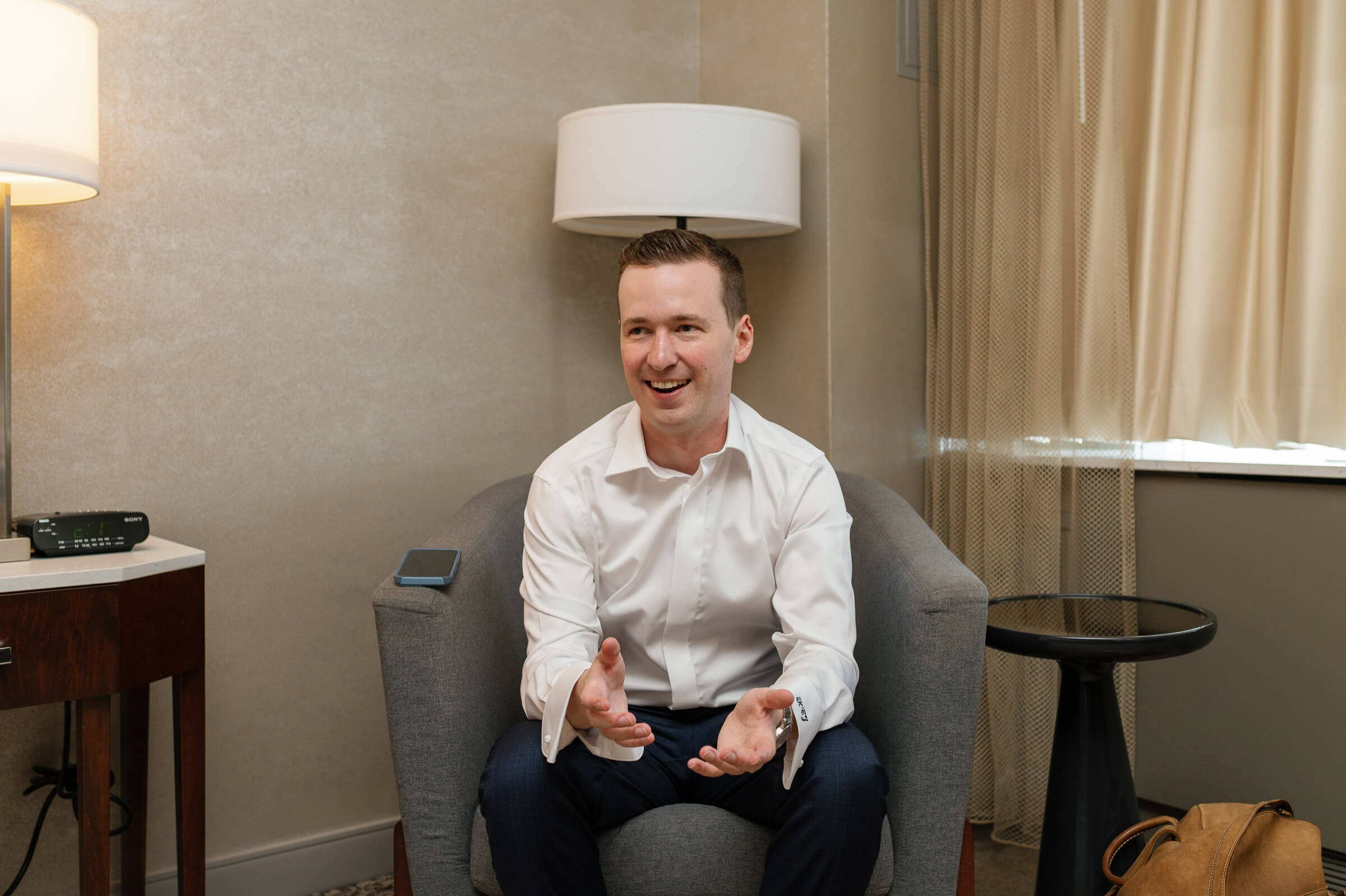 groom smiles while getting ready for wedding in halifax