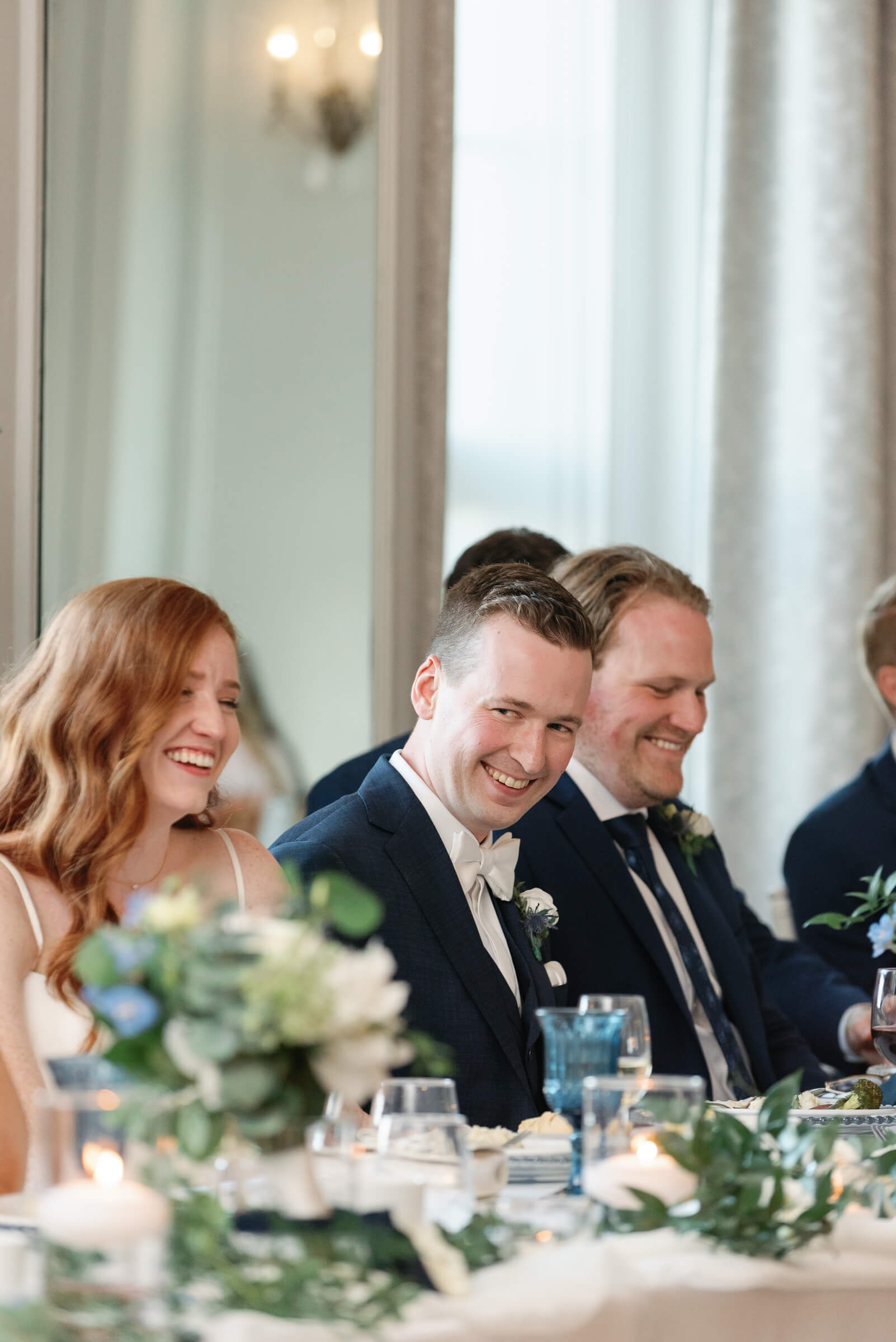 groom laughs during speech at his wedding