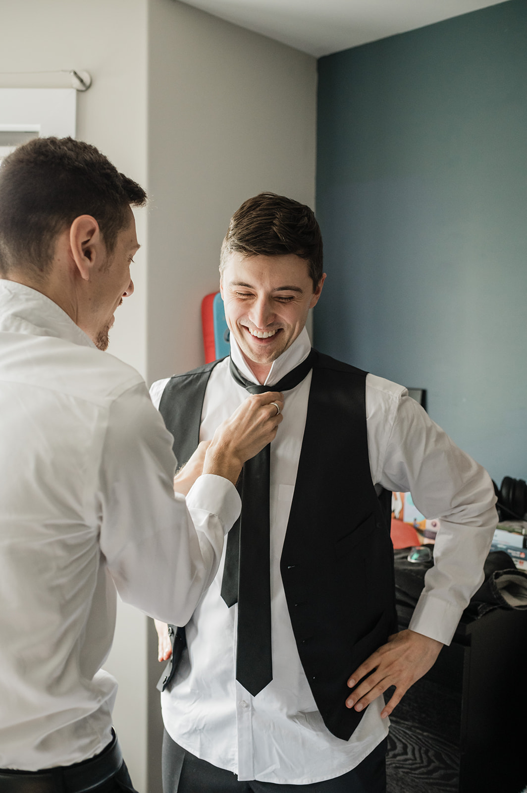 Groom has help getting ready for wedding